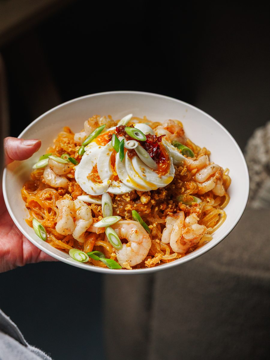 A bowl of prawn pancit noodles with egg and spring onion at Mina's Table