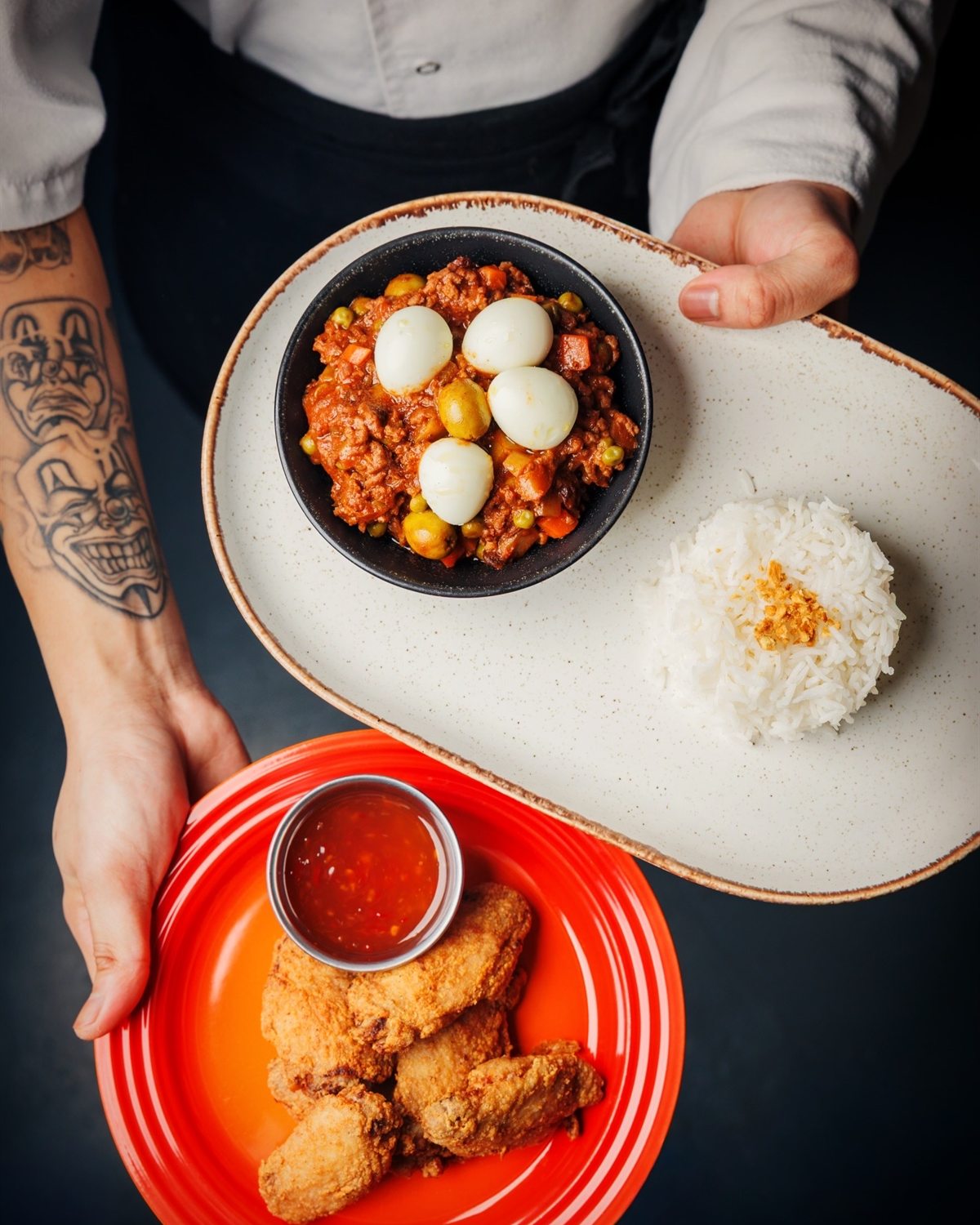 A Mina's Table set-menu spread of menudo with quail eggs, rice and crispy fried chicken