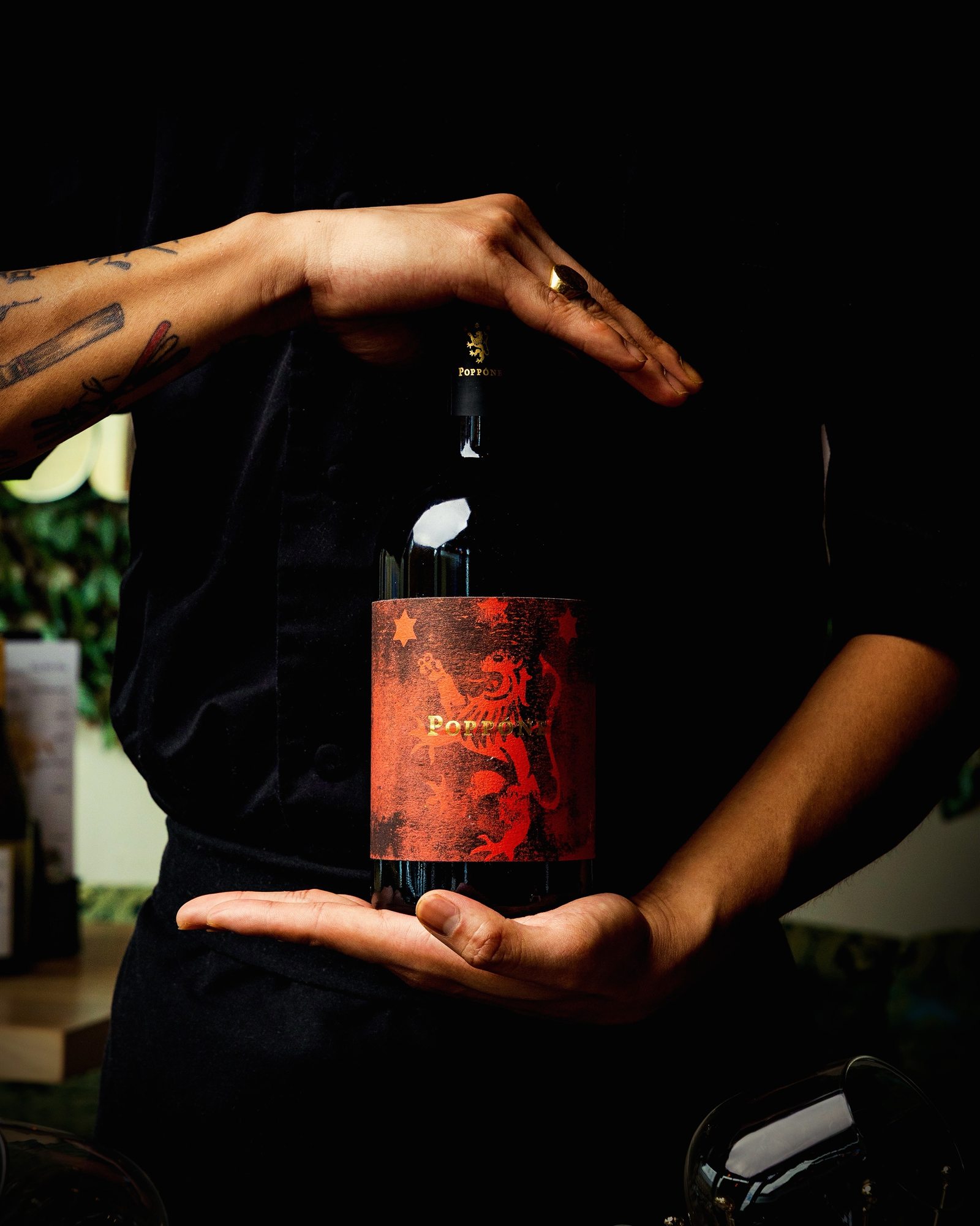 Sommelier presenting a bottle of Poppóne red wine at Mina's Table