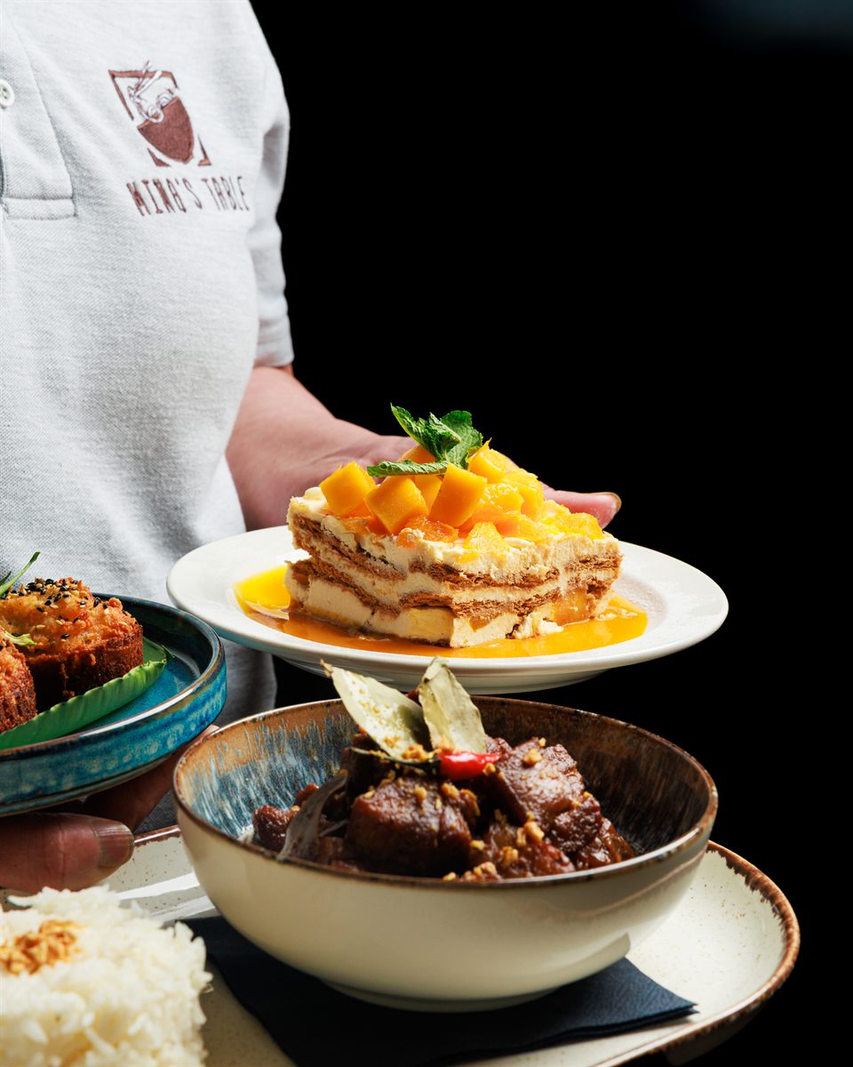 A layered mango dessert and a bowl of braised pork carried out together