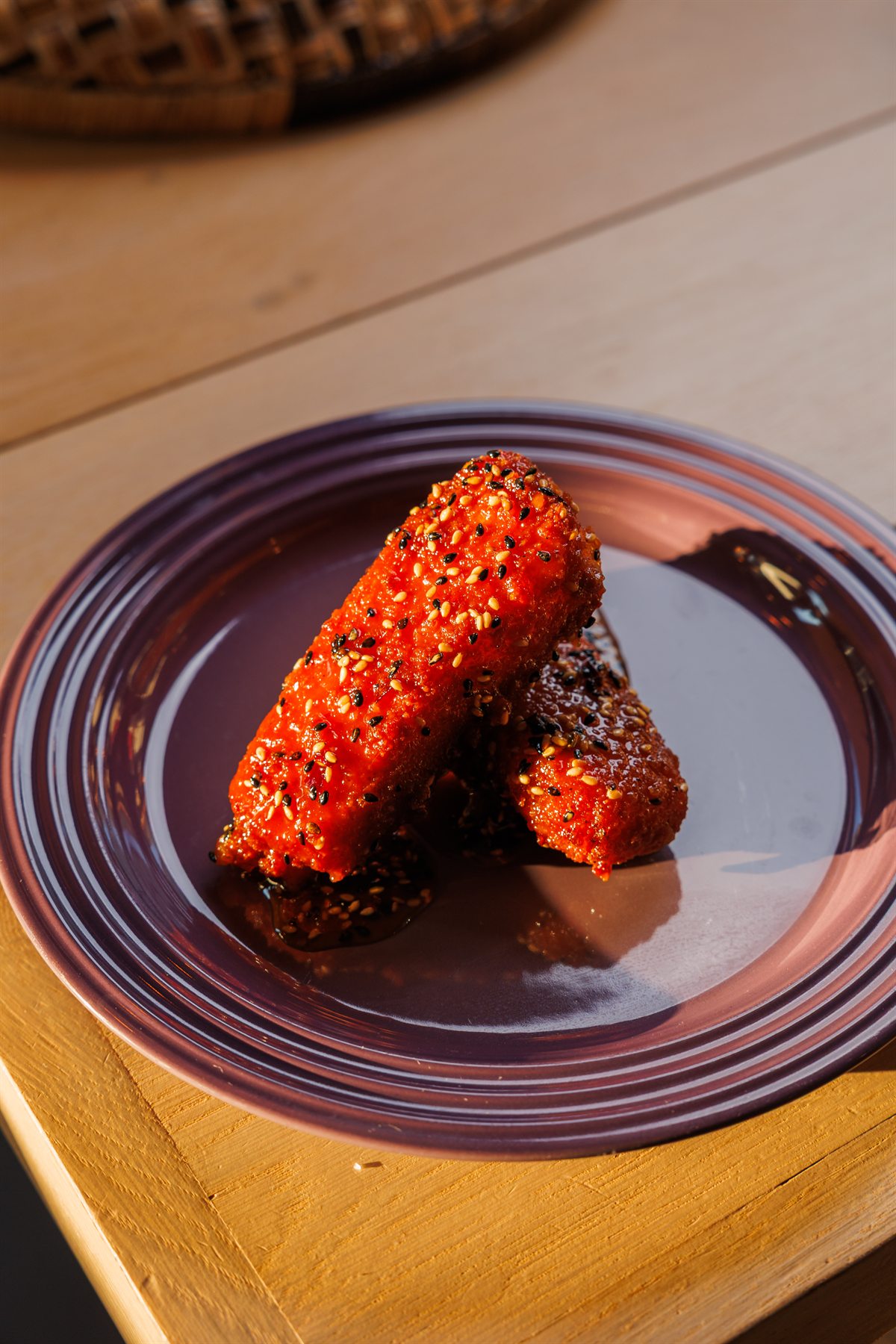 Close-up of crispy sesame-glazed mozzarella catching the light
